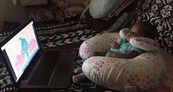 Kid Sitting Comfortably And Watching Laptop
