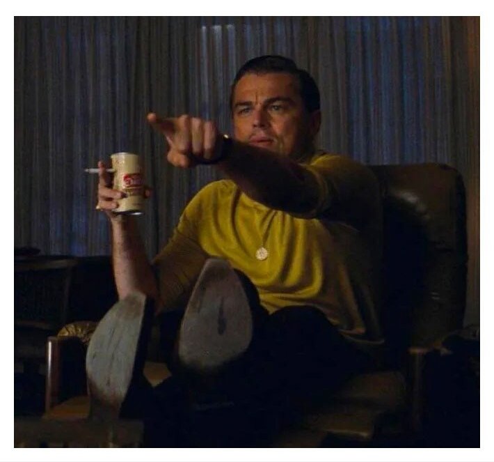Leonardo DiCaprio showing finger towards Television-Leonardo DeCaprio pointing towards Television-Once upon a time in hollywood-leonardo dicaprio in green tshirt 90s style-meme template