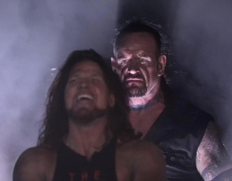 Angry Undertaker and Smiling Wrestler-Undertaker standing behind wrester-latest meme templates-